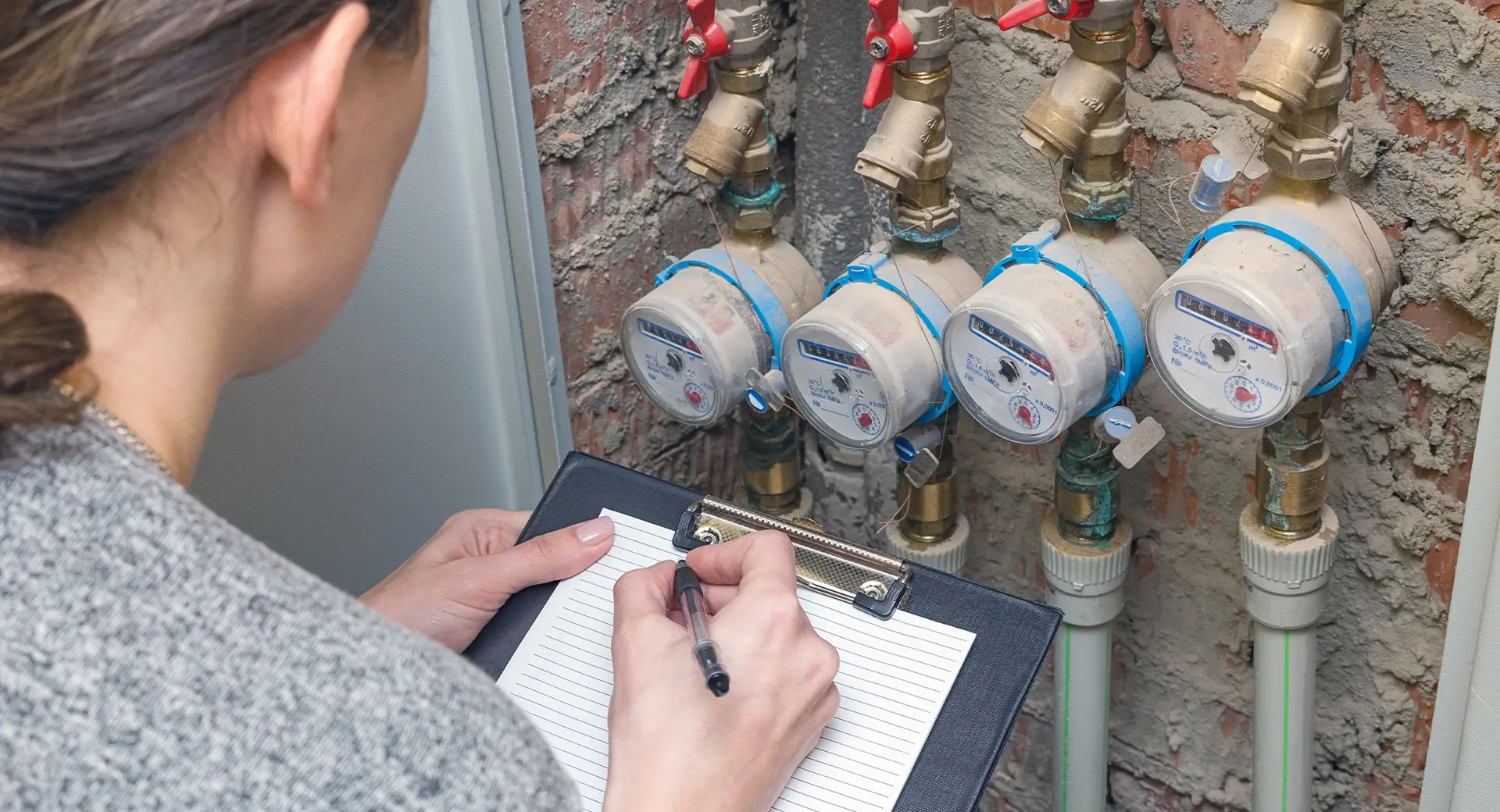 A person taking several water meter readings