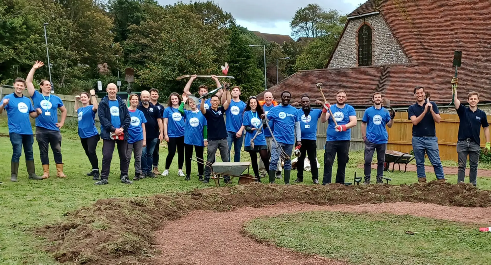 A group photo of volunteers standing in a field