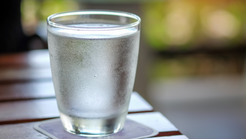 A glass of water on a coaster