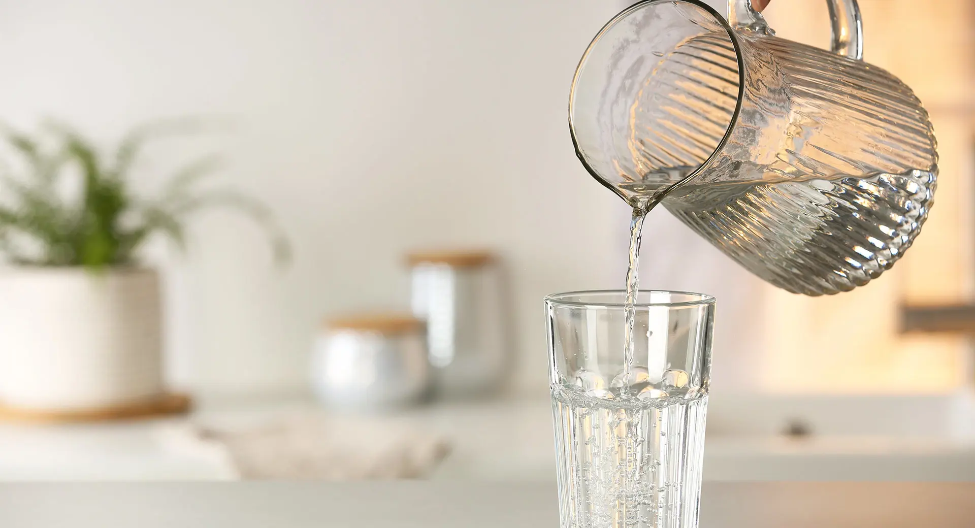 Water being poured in a glass from a jug