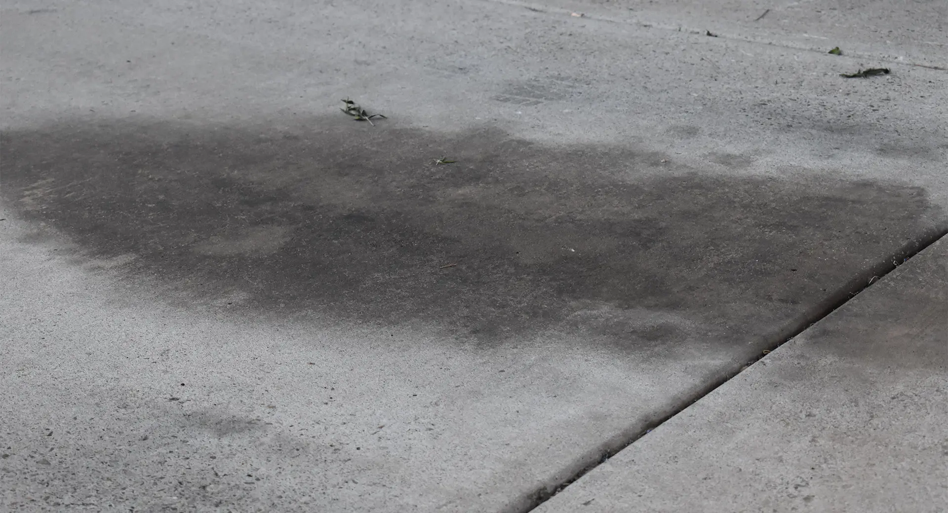 A path with water lying ontop of the concrete 