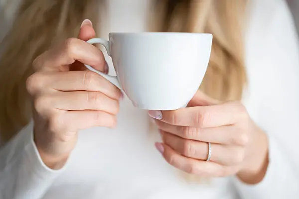 A person holding a cup of tea